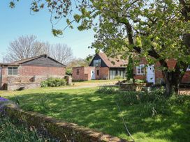 An outdoor view of buildings and trees at The Cart House in Sudbourne Near Orford