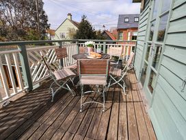 An outdoor deck with a table and chairs at Robert Sadler's Studio in Aldeburgh
