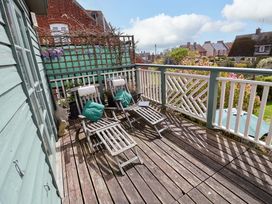An outdoor deck with chairs and a table at Robert Sadler's Studio in Aldeburgh