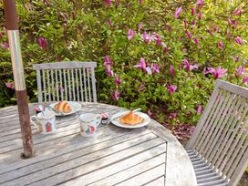 Outdoor seating area with a table and chairs at Robert Sadler's Studio in Aldeburgh