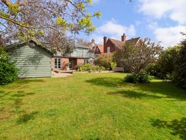 A garden with a house and trees at Robert Sadler's Studio Aldeburgh