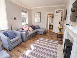 A living room with a sofa and armchair at The Round House in Easton near Framlingham
