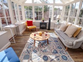 A conservatory with furniture and decor at The Round House in Easton near Framlingham