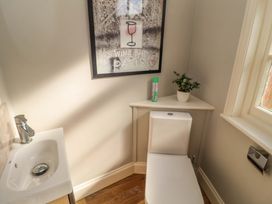 A bathroom with a toilet and sink at The Round House in Easton near Framlingham