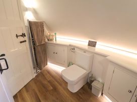 A bathroom with a toilet, towel rail, and sink at The Round House Easton near Framlingham