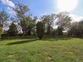 A garden with trees and a fence at The Round House Easton near Framlingham