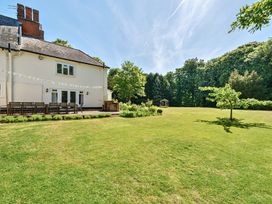 A large garden with a lawn tree and patio furniture outside a house at Bedingfield House nr Debenham