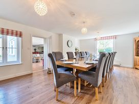 A dining room with a large wooden table and gray upholstered chairs at Bedingfield House nr Debenham Debenham
