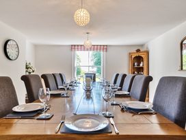 A dining room with a long wooden table set with plates glasses and cutlery at Bedingfield House nr Debenham Debenham