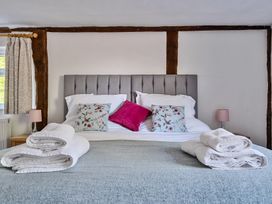 A bedroom with a double bed with pillows and folded towels at Bedingfield House nr Debenham Debenham 