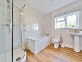 A bathroom with a shower cubicle bathtub toilet and pedestal sink at Bedingfield House nr Debenham in Debenham