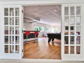 A games room with a pool table red bar stools and sofas at Bedingfield House nr Debenham Debenham 