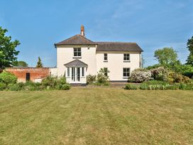A white two-story house with a garden and lawn in front at Bedingfield House nr Debenham Debenham