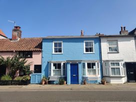 A row of houses with blue and pink facades at Seaflower, Aldeburgh