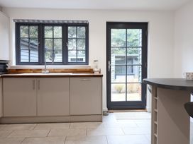 A kitchen with a sink and cabinets at Corner Cottage, Thorpeness