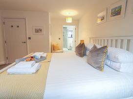 A bedroom with a bed and tray on it at Corner Cottage, Thorpeness