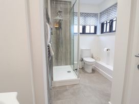 A bathroom with a shower and toilet at Corner Cottage, Thorpeness