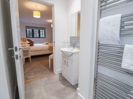 A bathroom with sink and towel rail at Corner Cottage, Thorpeness