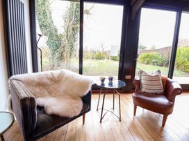 A living room with a chair and table at Fishpond House, Sotherton