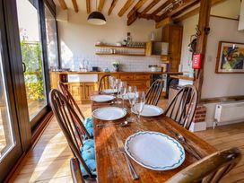 A dining room with a table set for dinner at Fishpond House, Sotherton Halesworth