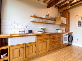 A kitchen with wooden cabinets and a sink at Fishpond House, Sotherton