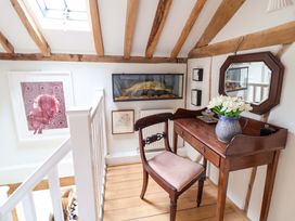 A hallway with a desk, chair, and wall art at Fishpond House, Sotherton