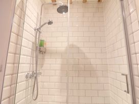 A shower with a wall and soap dispenser at Fishpond House, Sotherton