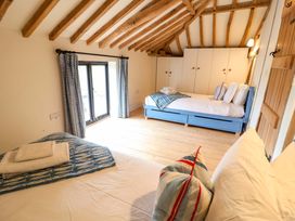 A bedroom with beds and wardrobe at Fishpond House, Sotherton
