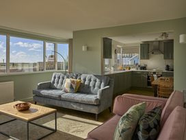 A living room with a sofa and coffee table at Harbour Lights in Southwold