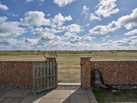 A gate and grass area at Harbour Lights in Southwold