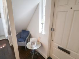 A hallway with a chair and table at High Ground, Reydon