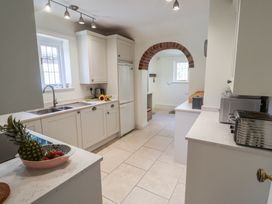 A kitchen with cabinets and a sink at High Ground, Reydon