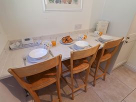 A kitchen with a table set for breakfast at High Ground, Reydon