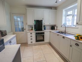 A kitchen with cabinets, oven, sink, and appliances at High Ground, Reydon