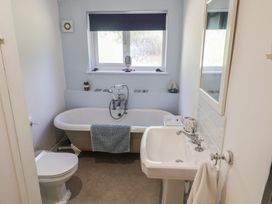 A bathroom with a bathtub, sink, and toilet at High Ground, Reydon