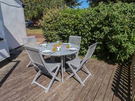 An outdoor dining area with a table and chairs at High Ground, Reydon