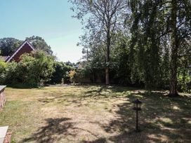 A garden with grass and trees at High Ground, Reydon
