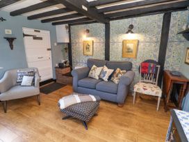 A living room with a sofa and armchair at Cherry Tree Cottage, Woodbridge