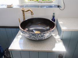 A sink with a faucet and a countertop at Cherry Tree Cottage, Woodbridge