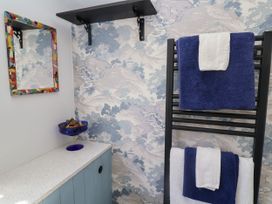 A bathroom with towels on a rack and decor at Cherry Tree Cottage, Woodbridge