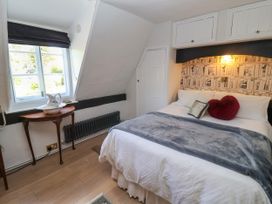 A bedroom with a bed and side table at Cherry Tree Cottage, Woodbridge