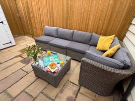 An outdoor seating area with a sofa and coffee table at 11 Crabbe Street, Aldeburgh