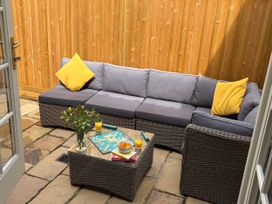 A snug area with a sectional sofa and coffee table at 11 Crabbe Street, Aldeburgh
