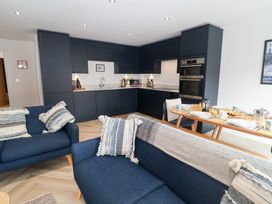 A kitchen with couches and dining set at Salt Marsh House, Southwold