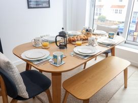 A dining table set with plates and drinks at Salt Marsh House, Southwold
