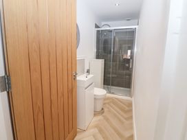 A bathroom with a shower, toilet, and sink at Salt Marsh House, Southwold