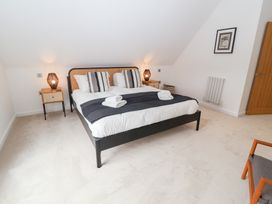 A bedroom with a double bed and bedside tables at Salt Marsh House, Southwold