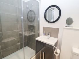 A bathroom with a shower and sink at Salt Marsh House, Southwold