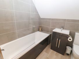A bathroom with a bathtub and sink at Salt Marsh House, Southwold