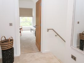 A hallway with steps and a door leading to a room at Salt Marsh House, Southwold